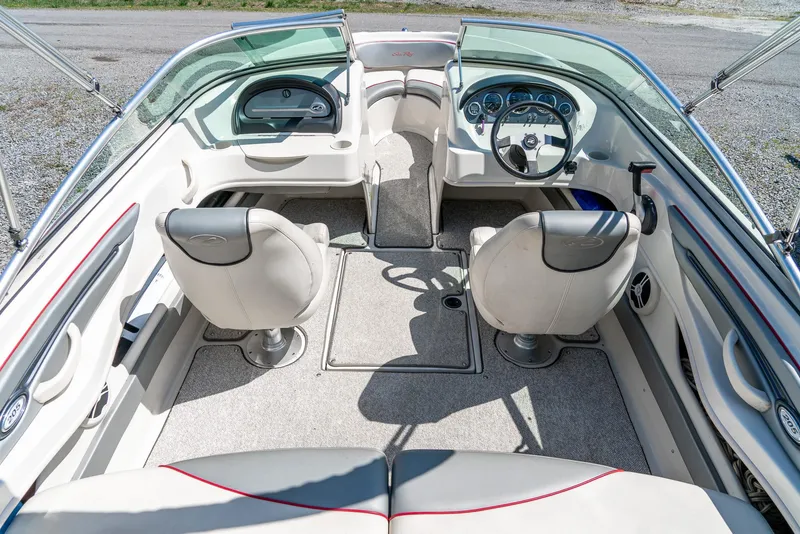 Slide: The Image of 2008 Sea Ray 205 Sport boat interior with dual seats and steering wheel. - 12