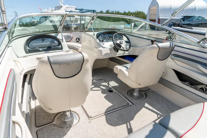 Slide: The Image of 2008 Sea Ray 205 Sport boat interior with steering wheel and seating. - 13