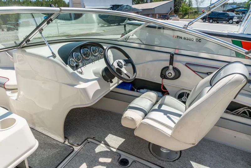 Slide: The Image of Interior of a 2008 Sea Ray 205 Sport boat, featuring steering wheel and dashboard. - 14