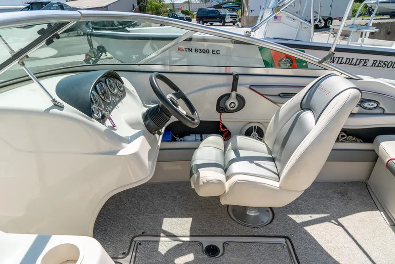 Slide: The Image of 2008 Sea Ray 205 Sport boat interior with steering wheel and captain's chair. - 15