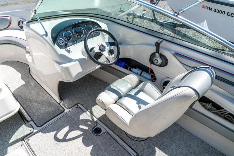 Slide: The Image of 2008 Sea Ray 205 Sport boat interior with steering wheel and dashboard controls. - 16