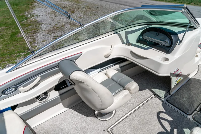Slide: The Image of 2008 Sea Ray 205 Sport boat interior with steering wheel and seating. - 19