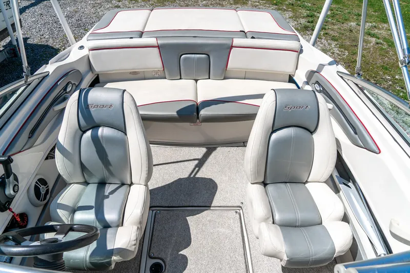 Slide: The Image of 2008 Sea Ray 205 Sport boat interior with gray and white seating. - 24
