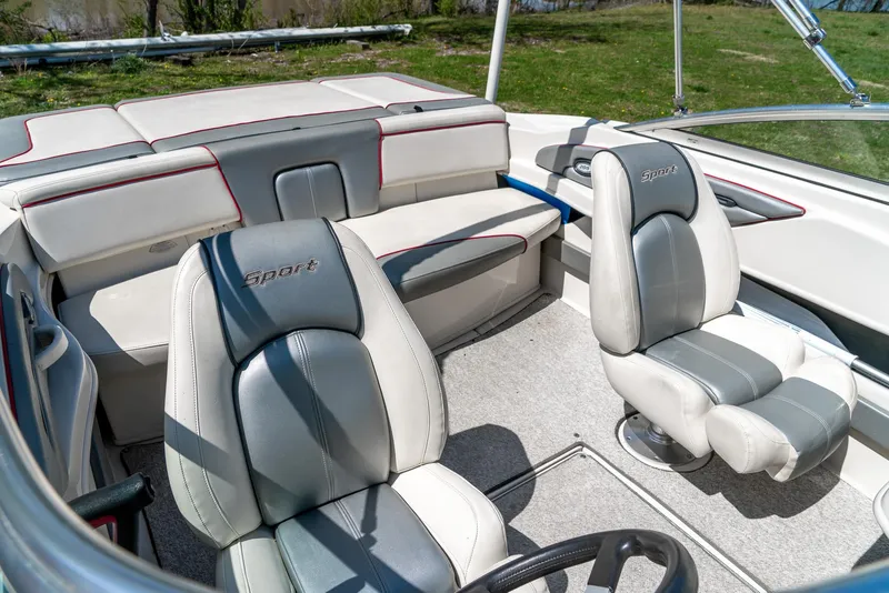 Slide: The Image of 2008 Sea Ray 205 Sport boat interior with gray and white seating. - 28