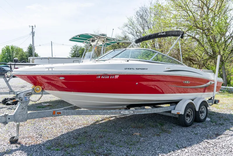 Slide: The Image of 2008 Sea Ray 205 Sport boat on trailer, red and white design, parked outdoors. - 5