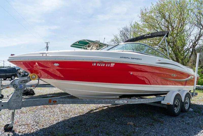 Slide: The Image of 2008 Sea Ray 205 Sport boat on trailer, red and white design, parked outdoors. - 6