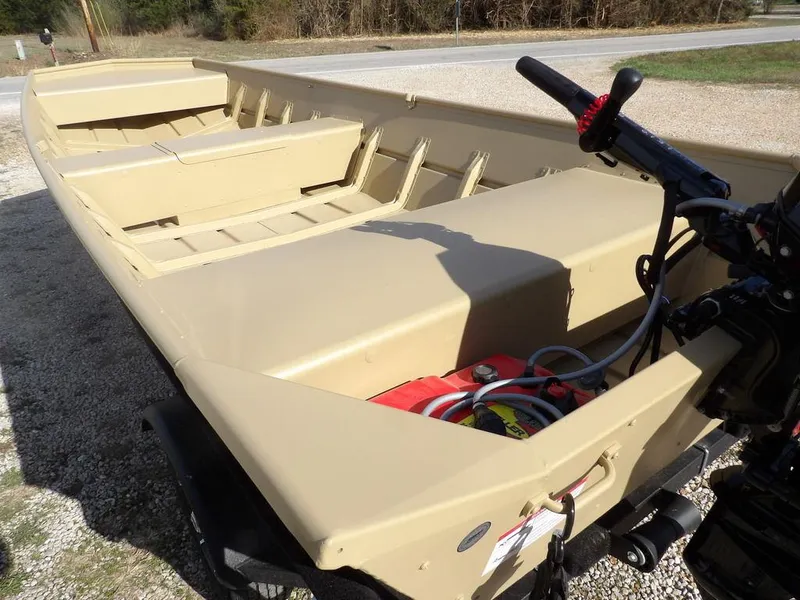 Slide: The Image of 2025 Crestliner 1648M CR Jon boat, beige, parked on gravel, with visible motor and interior seating. - 10