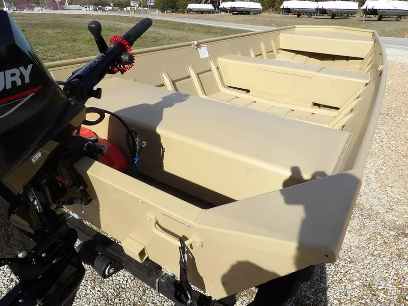 Slide: The Image of 2025 Crestliner 1648M CR Jon boat with Mercury motor, beige interior, parked on gravel. - 11