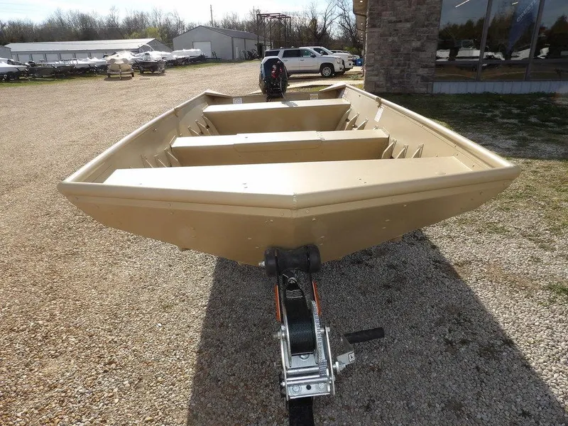 Slide: The Image of 2025 Crestliner 1648M CR Jon boat on trailer, parked on gravel near a building. - 3