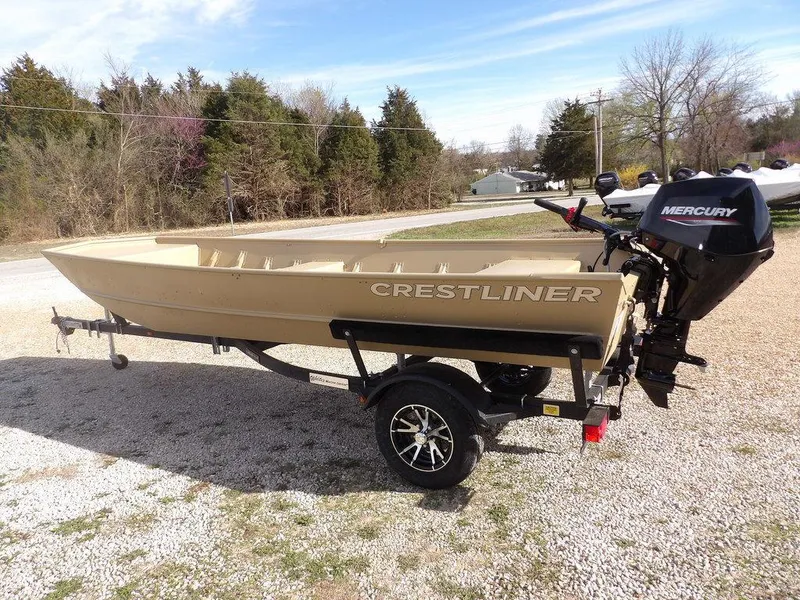 Slide: The Image of 2025 Crestliner 1648M CR Jon boat on trailer with Mercury outboard motor, parked outdoors. - 6