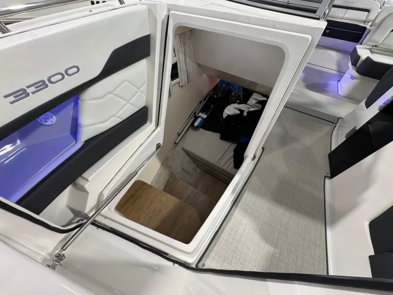 Slide: The Image of 2023 Regal 3300 boat interior with open storage compartment and seating area. - 13