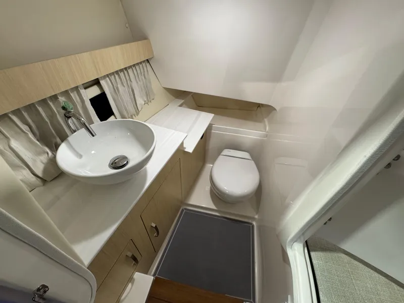 Slide: The Image of 2023 Regal 3300 boat bathroom with modern sink and toilet. - 14