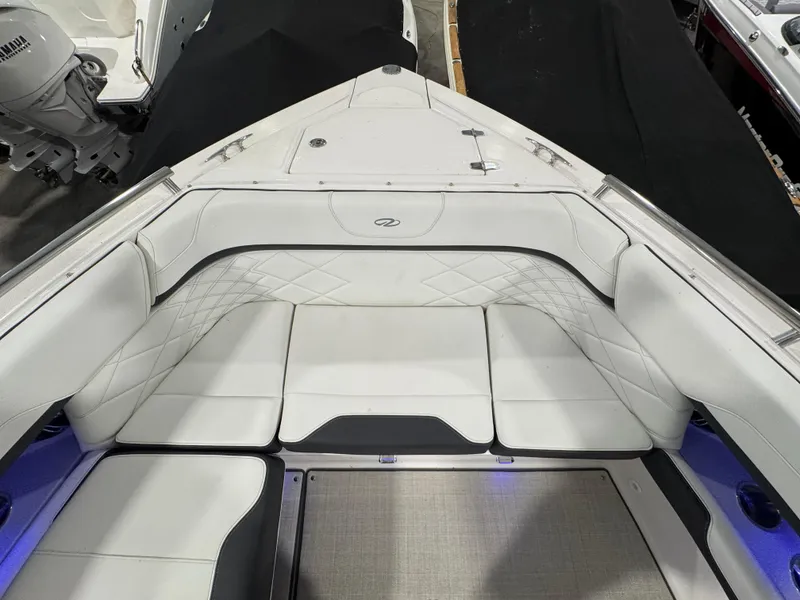 Slide: The Image of 2023 Regal 3300 boat interior with white cushioned seating and elegant design. - 17