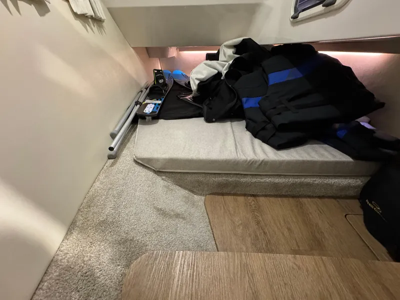 Slide: The Image of 2023 Regal 3300 cabin interior with storage and seating area. - 19