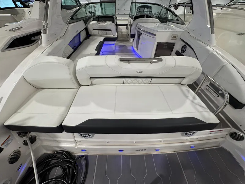 Slide: The Image of 2023 Regal 3300 boat interior with white seating and blue LED lighting. - 2