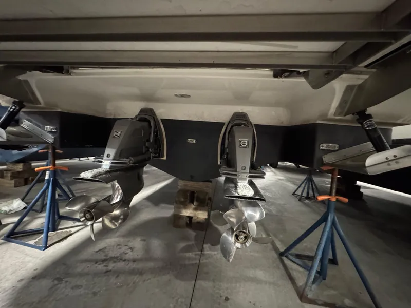 Slide: The Image of 2023 Regal 3300 boat propellers and outdrives on stands in a workshop. - 22