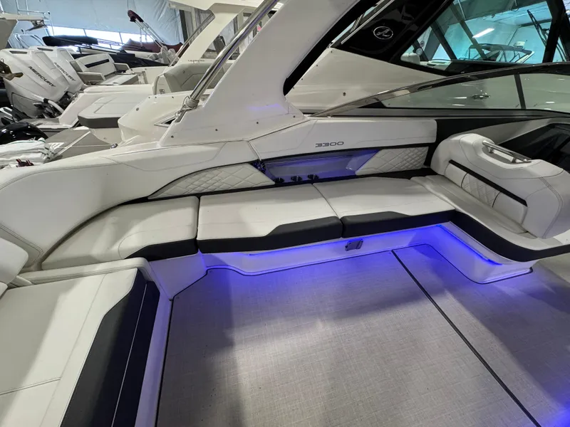 Slide: The Image of 2023 Regal 3300 boat interior with white seating and blue LED lighting. - 4