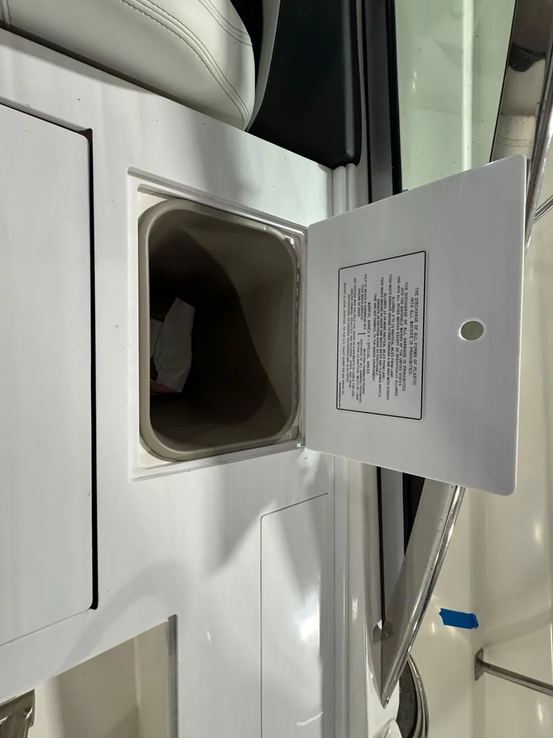 Slide: The Image of Open storage compartment on 2023 Regal 3300 boat with visible interior. - 7