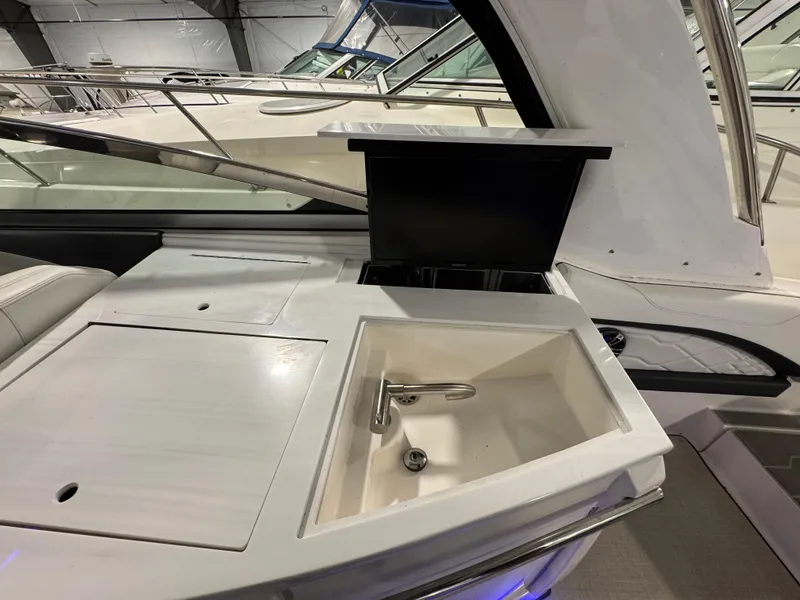 Slide: The Image of 2023 Regal 3300 yacht interior with sink and countertop in a showroom. - 8
