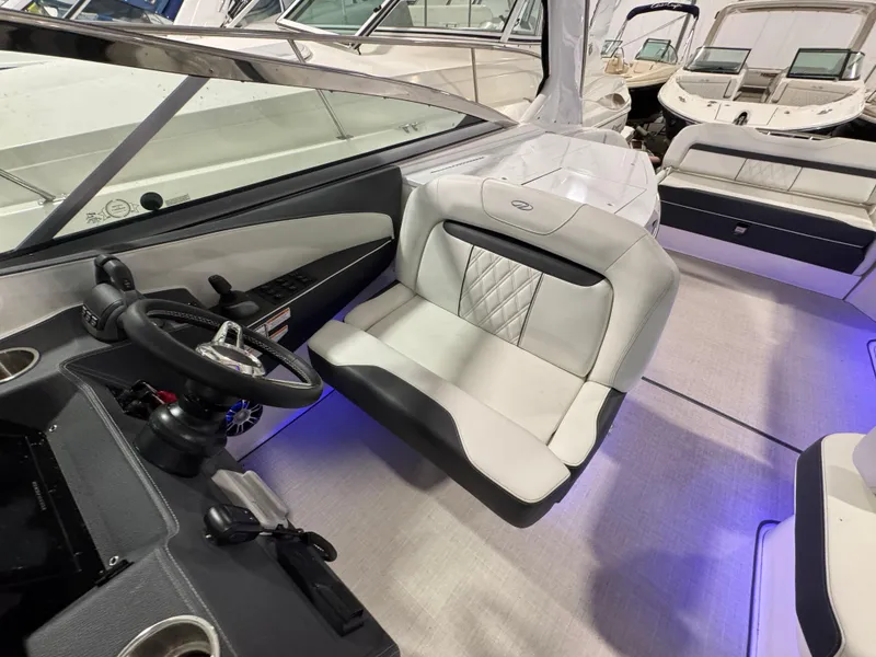 Slide: The Image of 2023 Regal 3300 boat interior with modern steering and luxurious seating. - 9