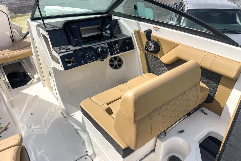 Slide: The Image of 2019 Sea Ray 270 Sundeck SDX interior with beige seating and modern dashboard. - 13