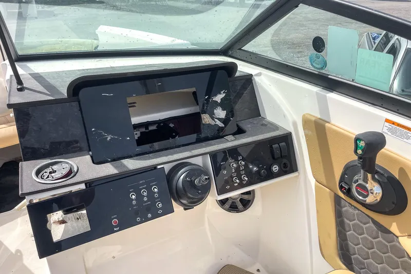 Slide: The Image of 2019 Sea Ray 270 Sundeck SDX dashboard with steering wheel and control panel. - 14