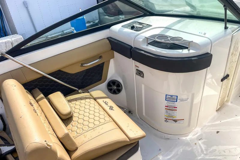 Slide: The Image of 2019 Sea Ray 270 Sundeck SDX interior with tan seating and console details. - 15