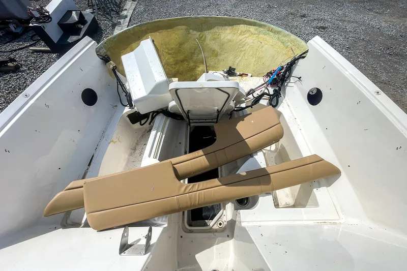 Slide: The Image of 2019 Sea Ray 270 Sundeck SDX boat interior with tan seating and open storage compartments. - 17