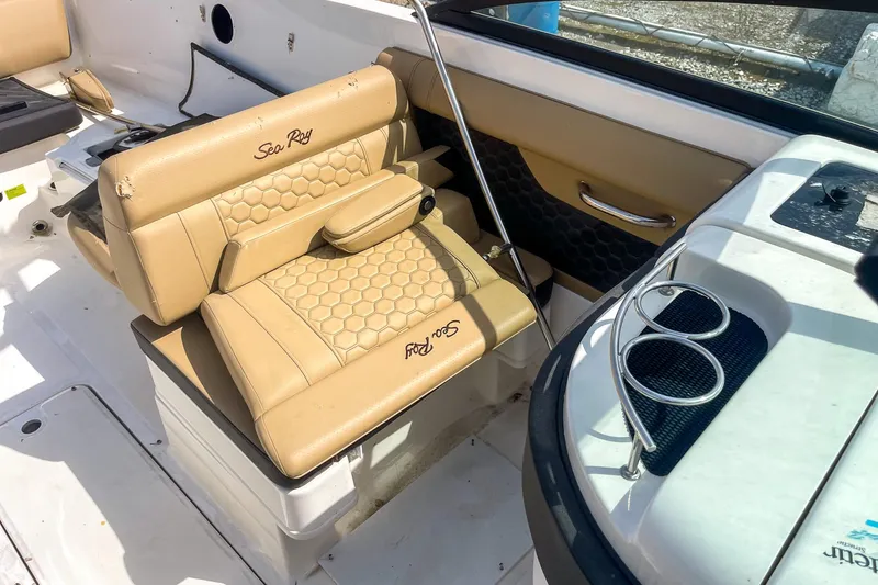 Slide: The Image of 2019 Sea Ray 270 Sundeck SDX boat interior with tan seating and cup holders. - 20