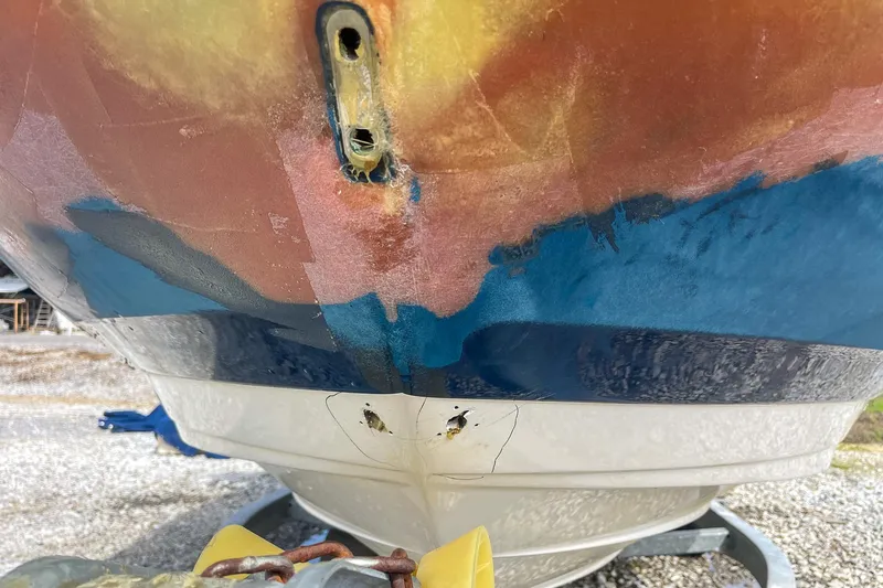 Slide: The Image of 2019 Sea Ray 270 Sundeck SDX boat hull with colorful paint and visible wear. - 24