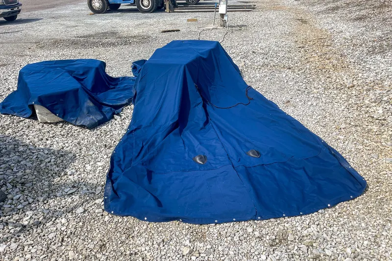Slide: The Image of Covered 2019 Sea Ray 270 Sundeck SDX on gravel lot with blue tarps. - 26