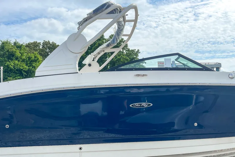 Slide: The Image of 2019 Sea Ray 270 Sundeck SDX boat with blue hull and sleek design. - 28
