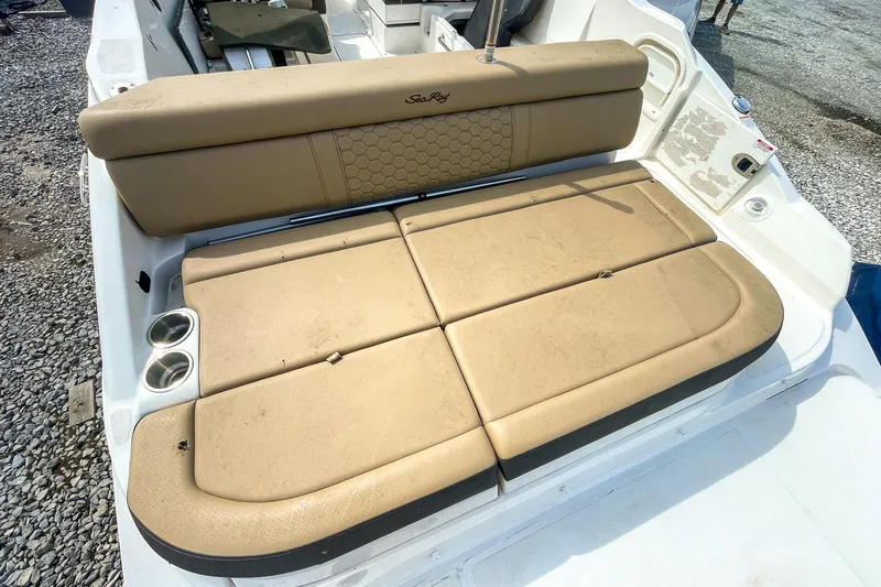 Slide: The Image of 2019 Sea Ray 270 Sundeck SDX boat with tan cushioned seating and cup holders. - 8