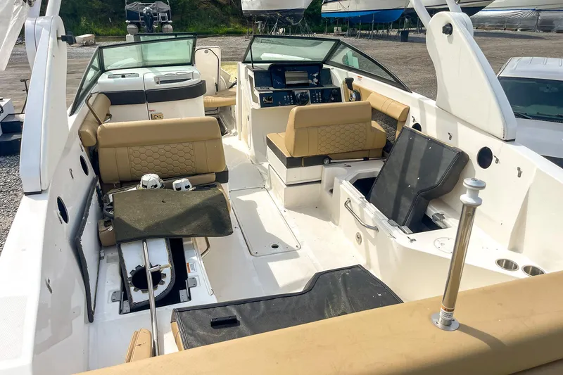 Slide: The Image of 2019 Sea Ray 270 Sundeck SDX interior with beige seating and modern dashboard. - 9