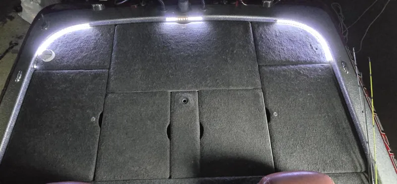 Slide: The Image of 2013 Skeeter ZX20 boat deck with LED lighting, showcasing carpeted surface and storage compartments. - 10