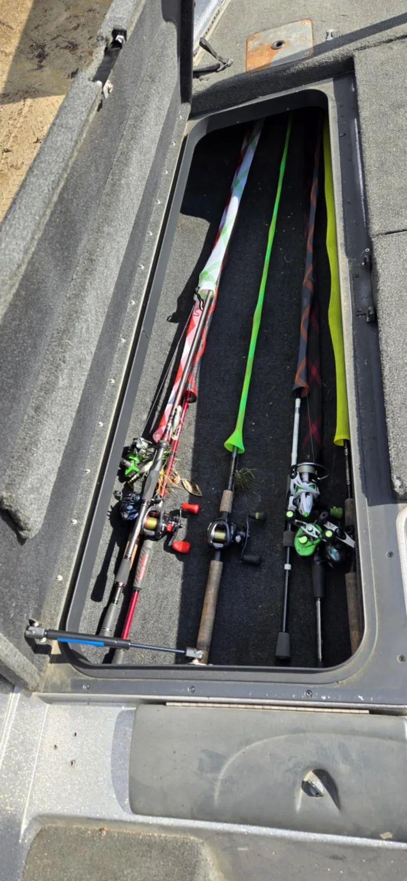 Slide: The Image of Fishing rods stored in a 2013 Skeeter ZX20 boat compartment. - 16