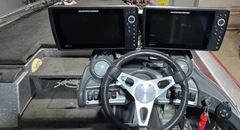 Slide: The Image of 2013 Skeeter ZX20 boat dashboard with dual Humminbird fish finders and steering wheel. - 7
