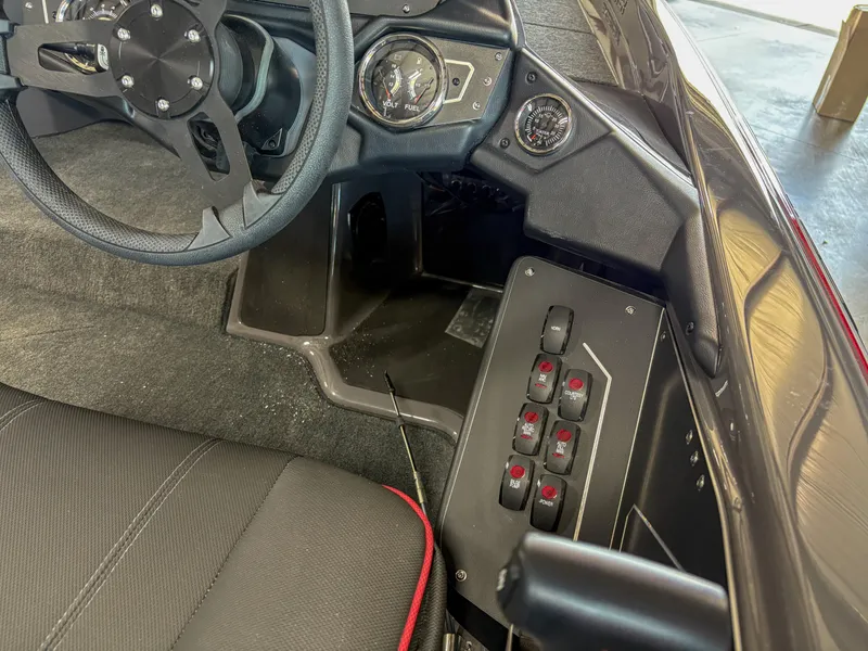 Slide: The Image of Interior view of 2025 Skeeter ZXR 19 boat dashboard with steering wheel and control panel. - 11