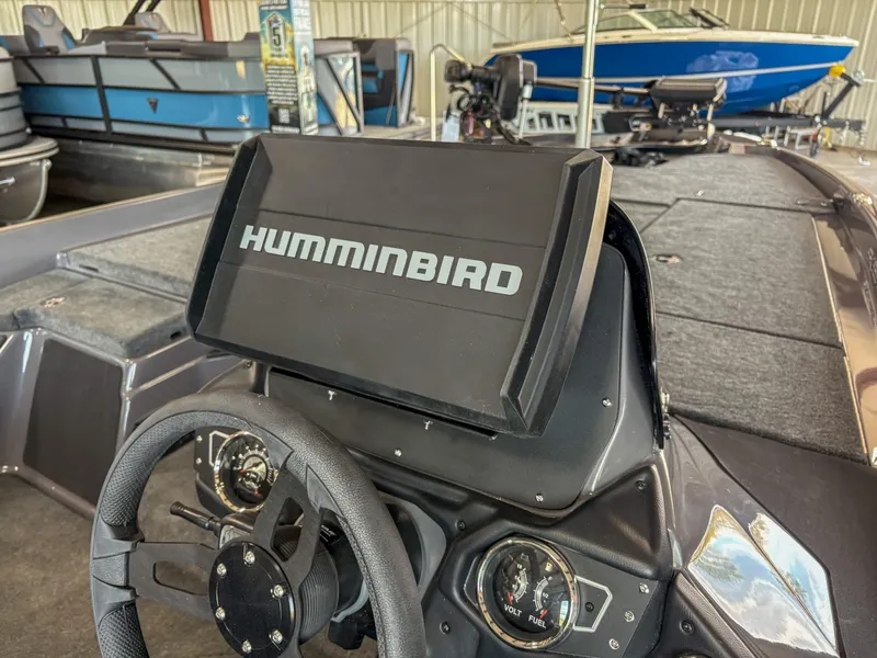 Slide: The Image of Skeeter ZXR 19 boat dashboard with Humminbird display, steering wheel, and gauges, 2025 model. - 9