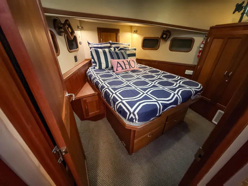 Slide: The Image of Cozy cabin interior of 2003 American Tug 34 with nautical-themed bedding. - 29