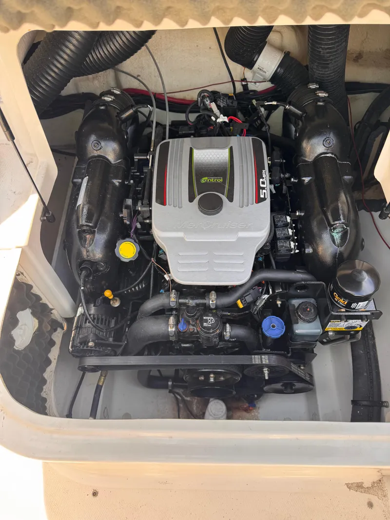 Slide: The Image of Engine compartment of a 2012 Sea Ray 200 SD boat, featuring a MerCruiser 5.0L engine. - 14
