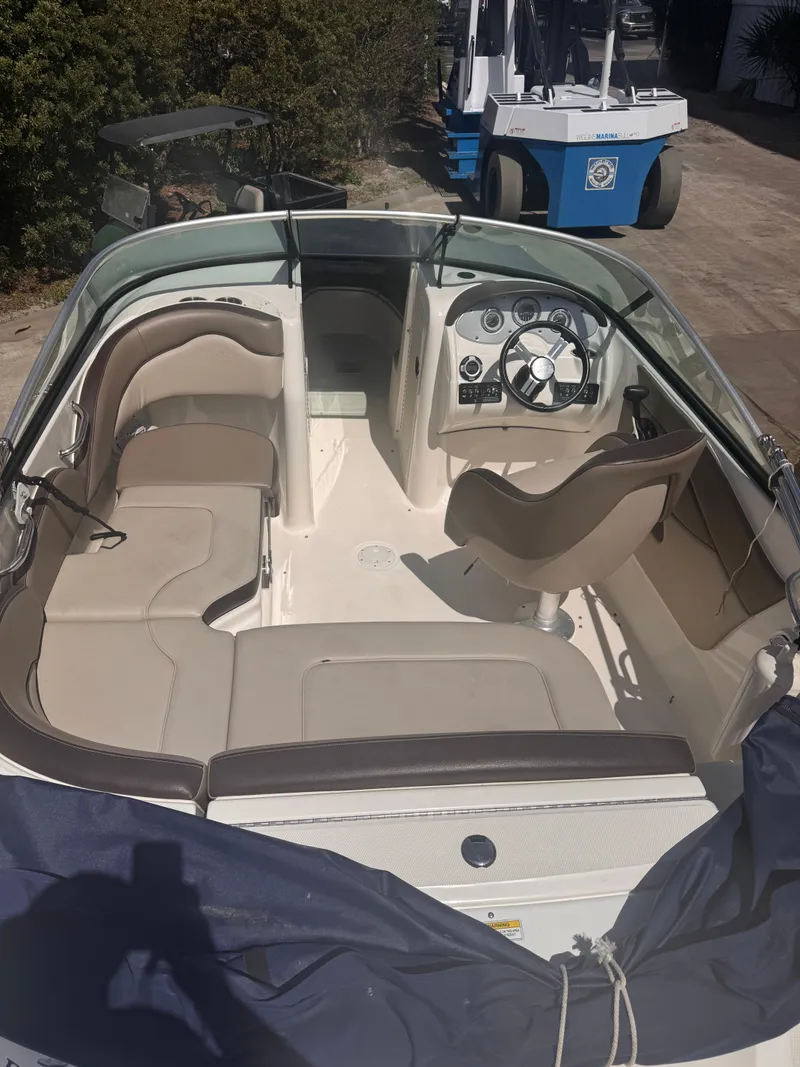 Slide: The Image of 2012 Sea Ray 200 SD boat interior with beige seating and steering console. - 3