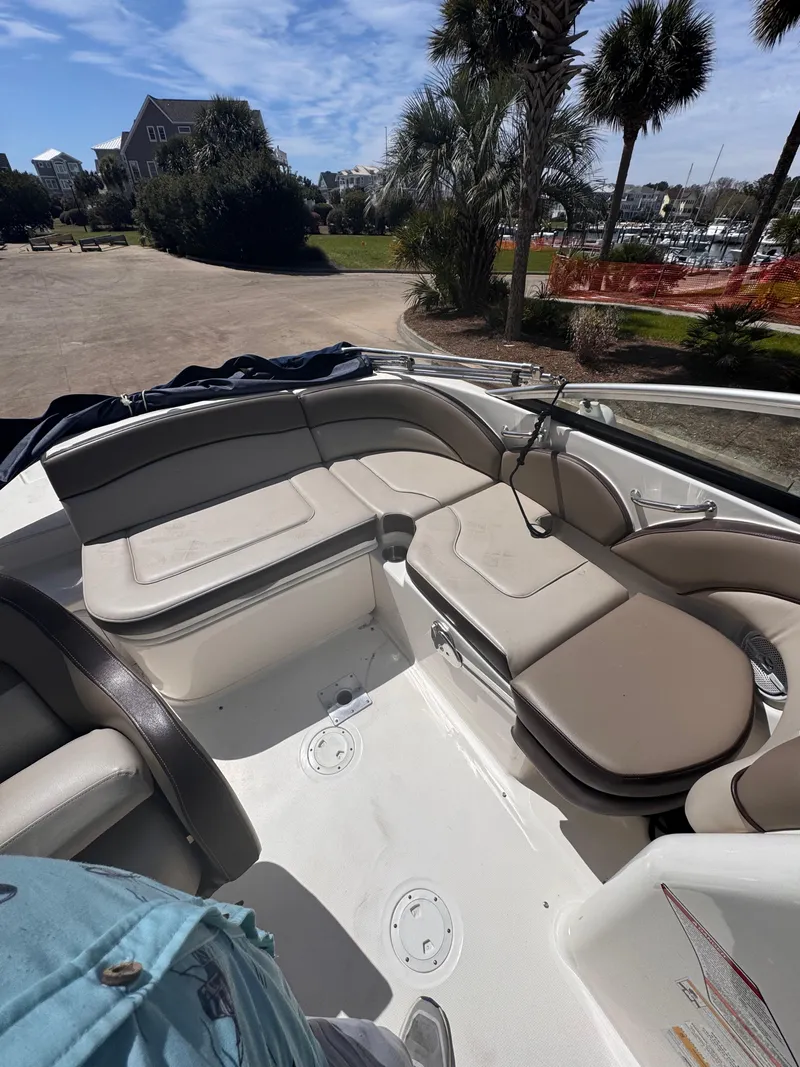 Slide: The Image of Interior of a 2012 Sea Ray 200 SD boat with beige seating and open deck. - 7