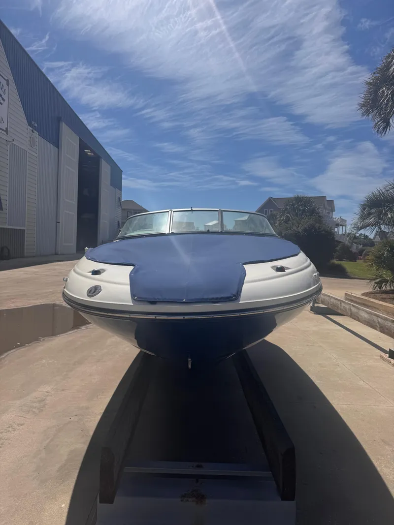 Slide: The Image of 2012 Sea Ray 200 SD boat on trailer under clear blue sky. - 9