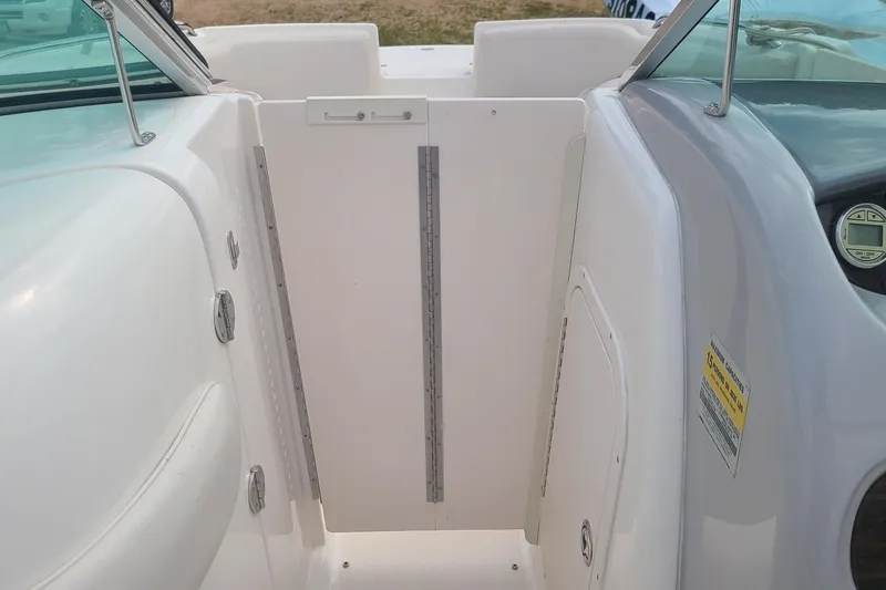 Slide: The Image of 2005 Chaparral 264 Sunesta boat interior with white panel and seating area. - 10