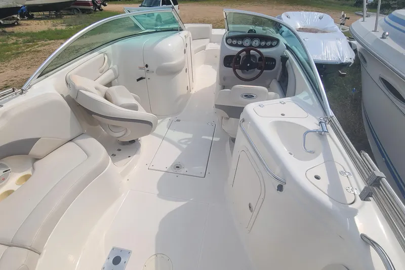 Slide: The Image of 2005 Chaparral 264 Sunesta boat interior with seating and steering wheel. - 13