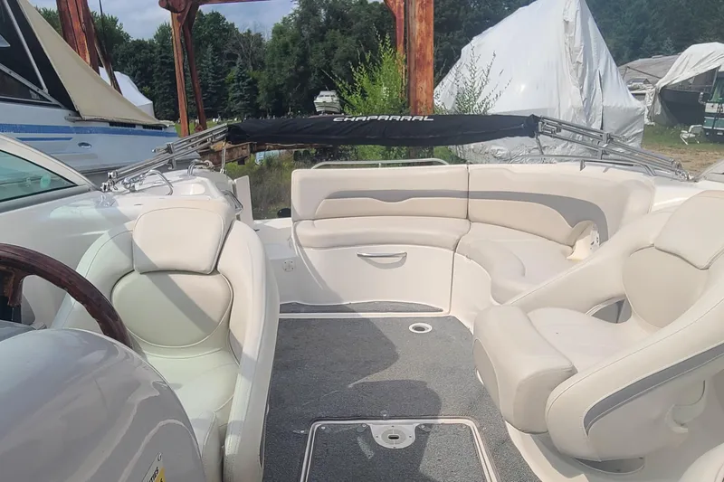 Slide: The Image of 2005 Chaparral 264 Sunesta boat interior with beige seating and wood accents. - 17