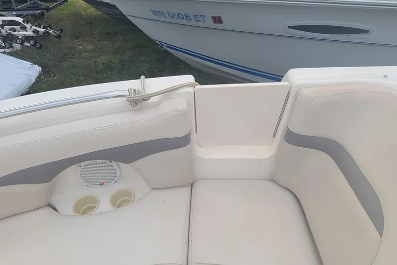 Slide: The Image of 2005 Chaparral 264 Sunesta boat interior with seating and cup holders. - 5