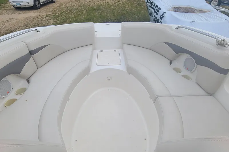 Slide: The Image of 2005 Chaparral 264 Sunesta boat interior with white seating and cup holders. - 6