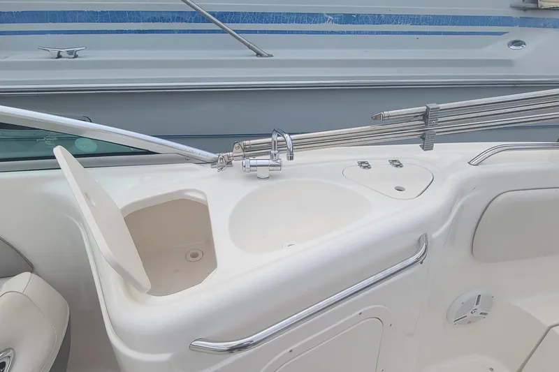 Slide: The Image of 2005 Chaparral 264 Sunesta boat interior with sink and storage compartment. - 8